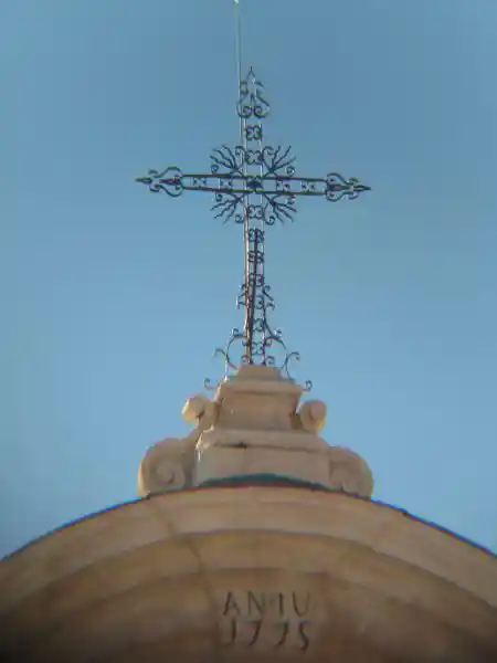 Cross with rays on top of a church